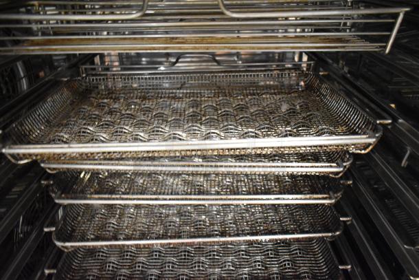 Interior view of a 2021 Rational iCombiPro convection oven showing stainless steel racks and trays. Used condition.