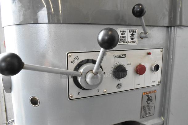 Hobart M802 dough mixer controls, featuring speed settings, clutch lever, and safety warnings. Durable stainless steel finish.