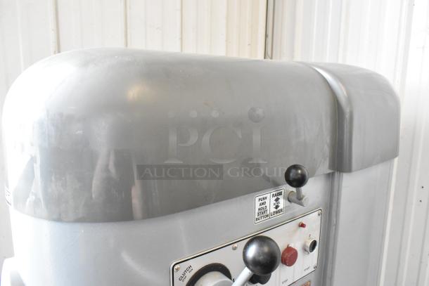 Hobart M802 commercial dough mixer, showing control panel with levers and buttons. Includes "Push and Hold Start Button" label.