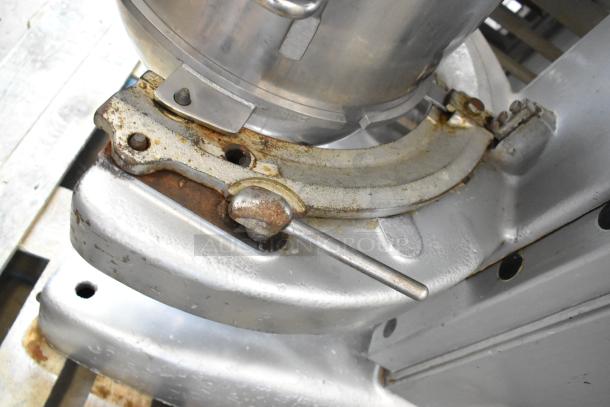 Hobart M802 metal base with visible wear, showing part of the stainless steel mixing bowl attachment system.
