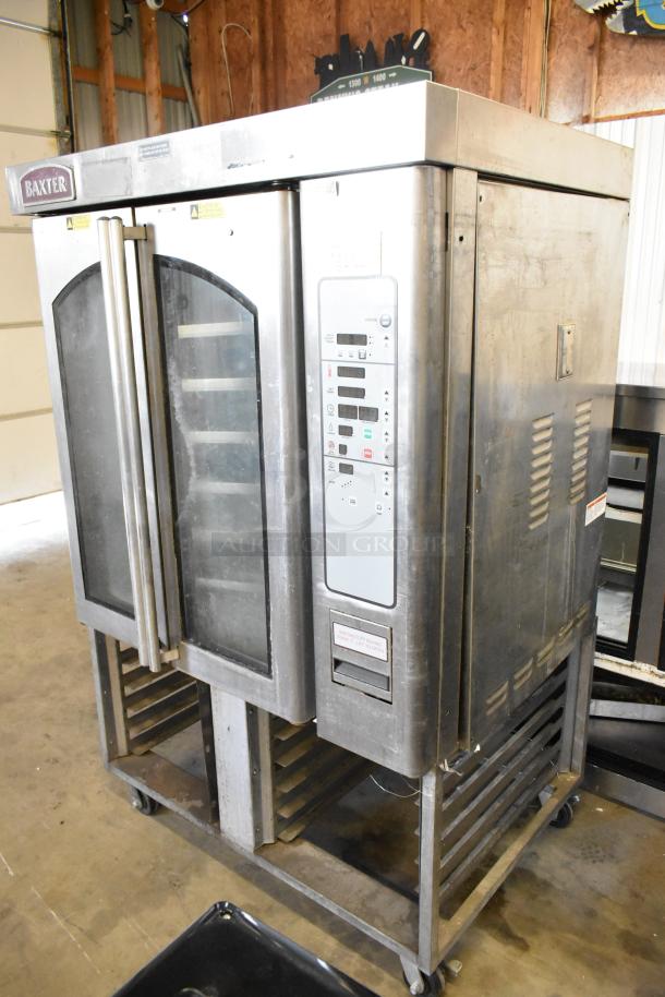 Baxter stainless steel commercial gas-powered mini rotating rack oven with dual pan rack, on commercial casters, used condition.