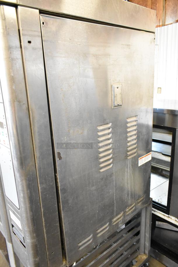 Baxter stainless steel mini rotating rack oven, natural gas powered, dual pan rack, on commercial casters, visible wear.