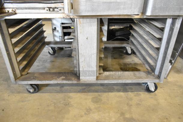 Baxter stainless steel mini rotating rack oven, natural gas powered, dual pan rack, on commercial casters, used condition.