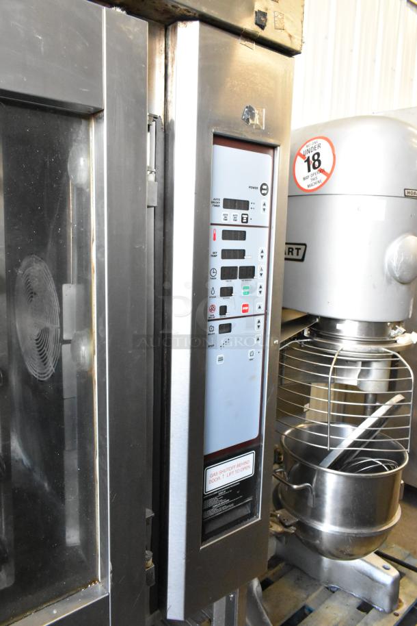 Baxter stainless steel commercial gas mini rotating rack oven with dual pan rack, control panel, and casters, in good condition.