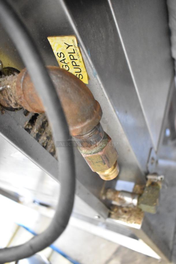 Baxter stainless steel rotating rack oven base, showing gas supply connection, used condition. Natural gas powered.