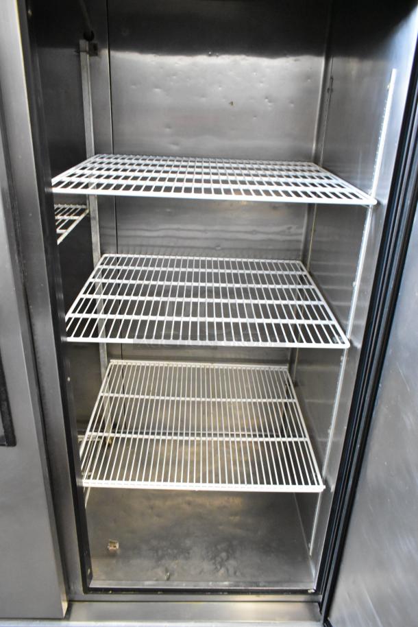True TS-49 stainless steel commercial cooler, 2 doors, poly-coated racks, on commercial casters, 115V, 1 phase.