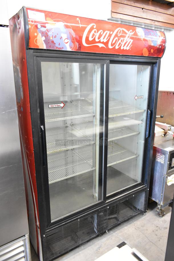 True GDM-45 commercial cooler, two glass doors, Coca-Cola branding, poly coated racks; 115V, 1 Phase, metal exterior.