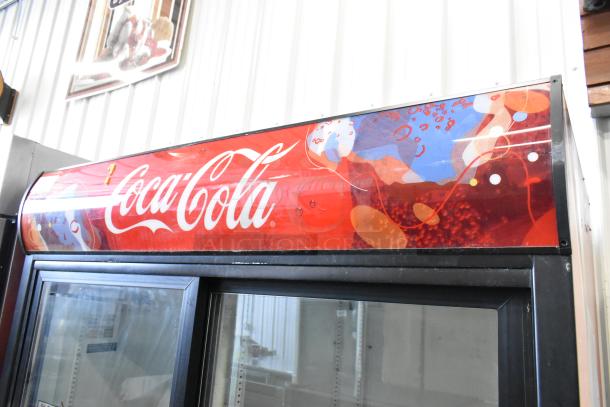 True GDM-45 commercial 2-door cooler merchandiser with Coca-Cola branding, features poly-coated racks, 115 volts, 1 phase.