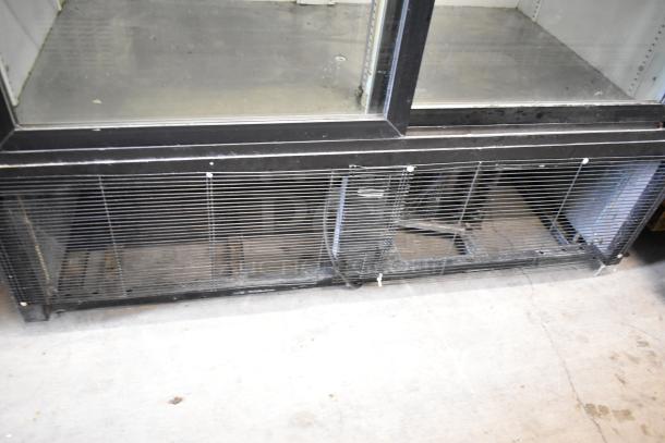 True GDM-45 commercial cooler, black metal, 2 glass doors, poly-coated racks, 115 volts, 1 phase, visible wear on bottom grille.