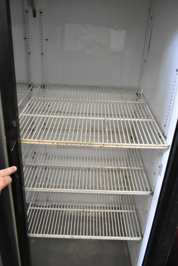 True GDM-45 commercial 2-door cooler merchandiser with poly-coated racks. Visible wear, white metal interior. 115V, 1 phase.