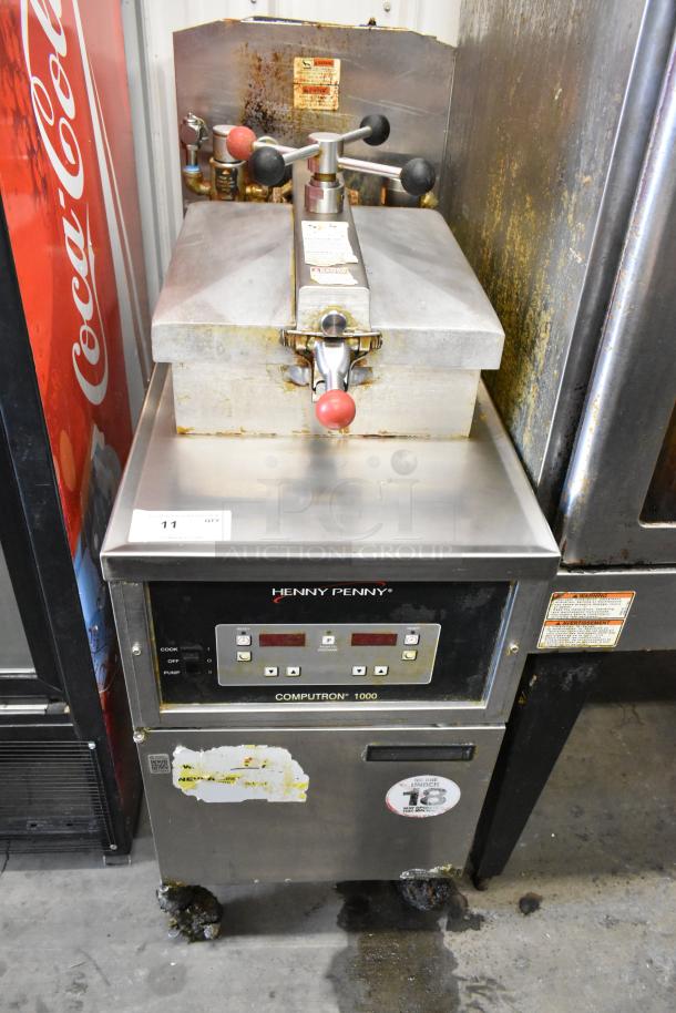 Henny Penny 600 stainless steel pressure fryer, natural gas, 80,000 BTU, on casters, with visible wear and control panel.