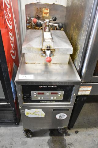 Henny Penny 600 stainless steel pressure fryer, natural gas, 80,000 BTU, on casters, with visible wear and control panel.