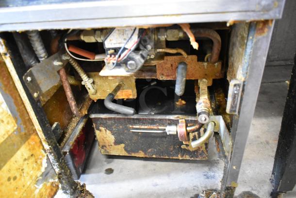 Henny Penny 600 pressure fryer inside view, showing rusted components and connectors. Natural gas powered, 80,000 BTU.