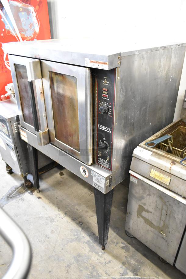 Hobart HGC5-11D3 stainless steel commercial gas convection oven with view-through doors, metal racks, and thermostatic controls.