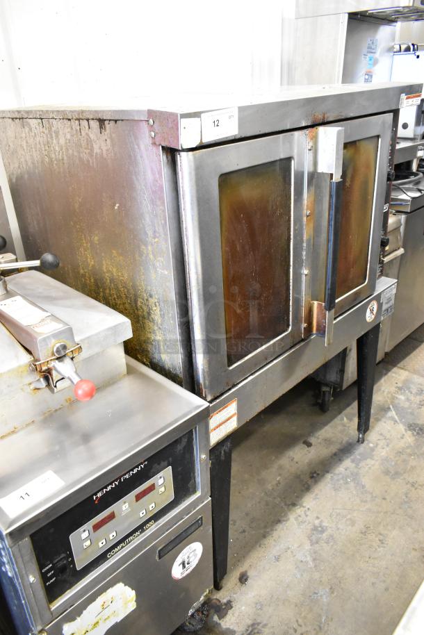 Hobart HGC5-11D3 stainless steel convection oven, gas-powered, view-through doors, metal racks, thermostatic controls, metal legs.