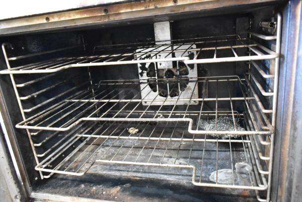 Hobart HGC5-11D3 convection oven interior, showing metal racks and signs of wear.