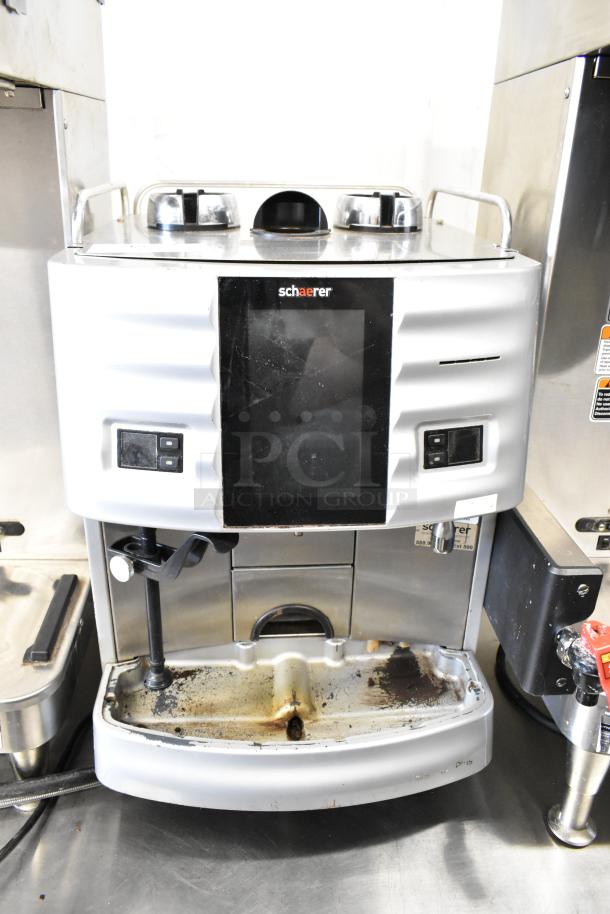 Schaerer metal commercial countertop espresso machine, missing hoppers, used condition, 120-208/240V, 1 phase, front view.