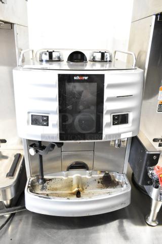 Schaerer metal commercial countertop espresso machine, missing hoppers, used condition, 120-208/240V, 1 phase, front view.