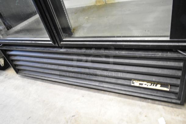 True GEM-49 two-door metal reach-in cooler, poly coated racks, 115 volts, one phase, commercial use, visible True branding.