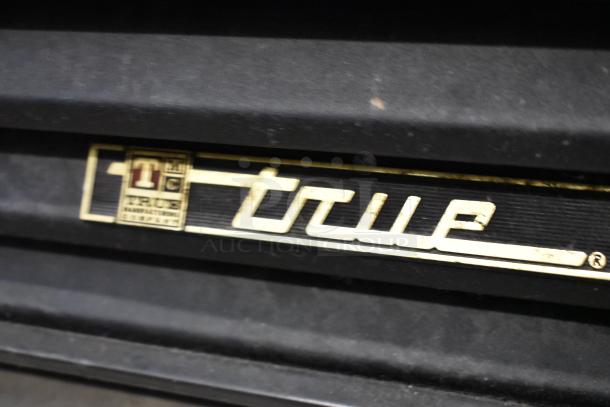 True GEM-49 metal commercial cooler badge with manufacturer's logo. Features dual doors and poly coated racks. 115 volts.