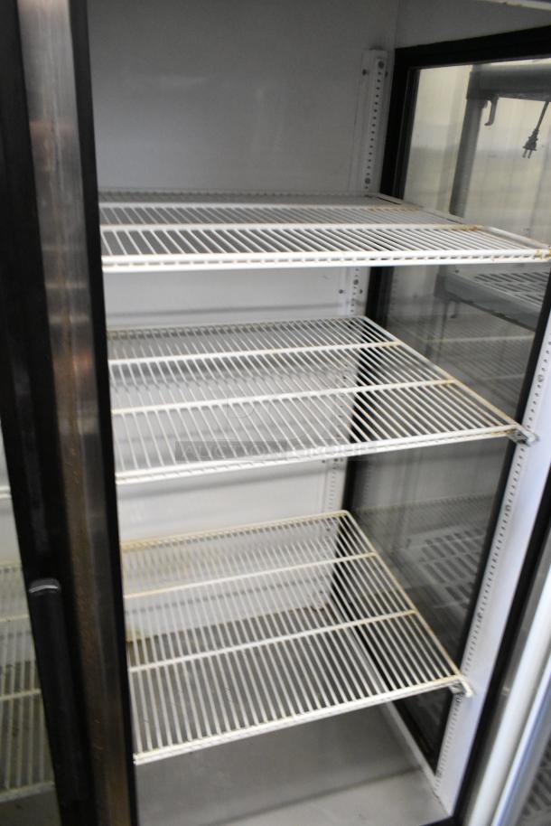 True GEM-49 commercial 2-door reach-in cooler with poly-coated racks, metal exterior, 115 volts, 1 phase, used condition.