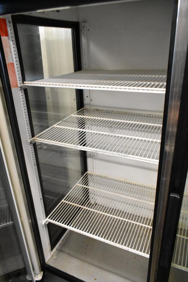 True GEM-49 metal 2-door commercial cooler with poly-coated racks, excellent condition, 115 volts, 1 phase.