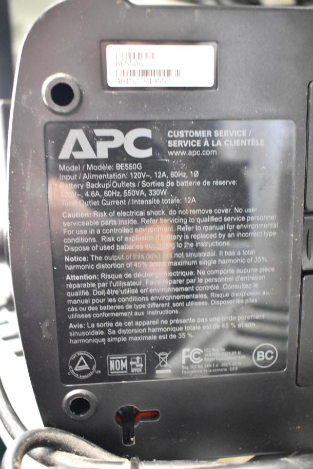 APC BE650G uninterruptible power supply, 120V, 550VA. Visible caution label and customer service info.