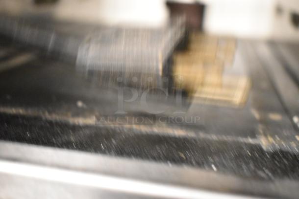 Blurry image of electrical plug, unable to discern details of Carter Hoffmann MC3W2SN01 stainless steel holding bin.
