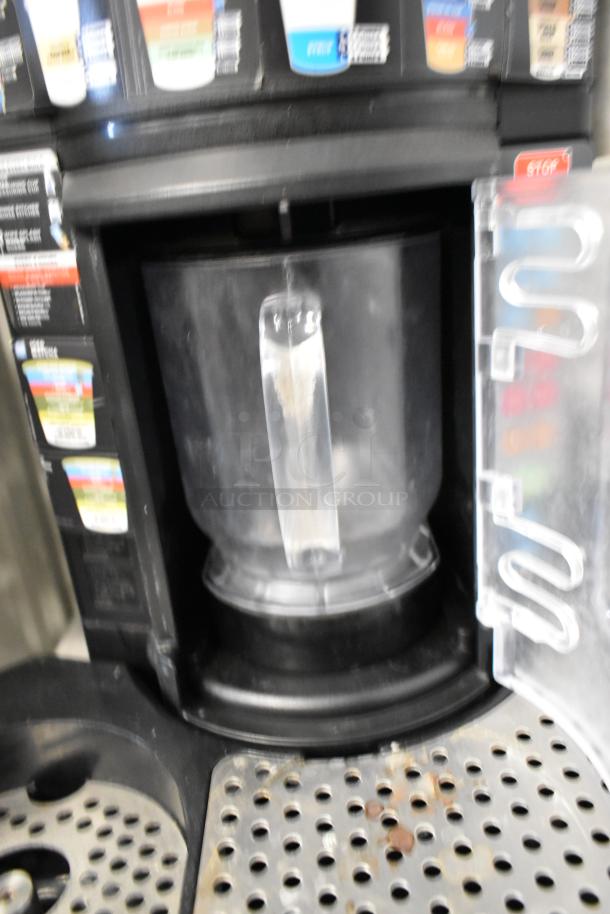 Taylor X83684-12 metal commercial countertop frozen beverage mixer; features a transparent blending chamber and labeled controls.