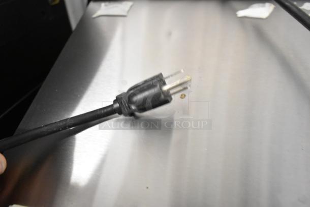 Taylor X83684-12 frozen beverage machine plug and cord on countertop, showcasing stainless steel finish.