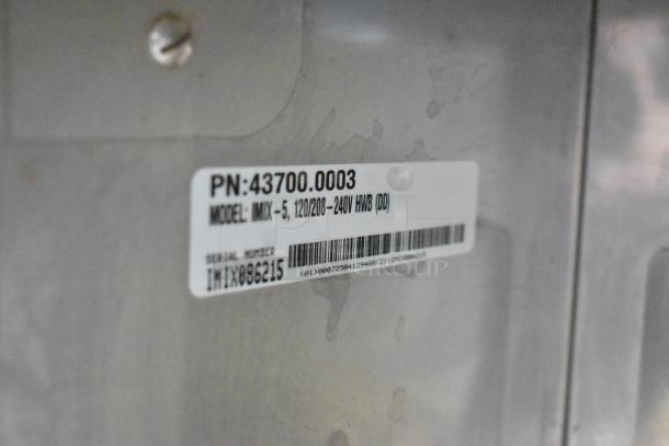 Bunn IMIX-5 cappuccino machine label, showing model, voltage specifications, and serial number on stainless steel surface.