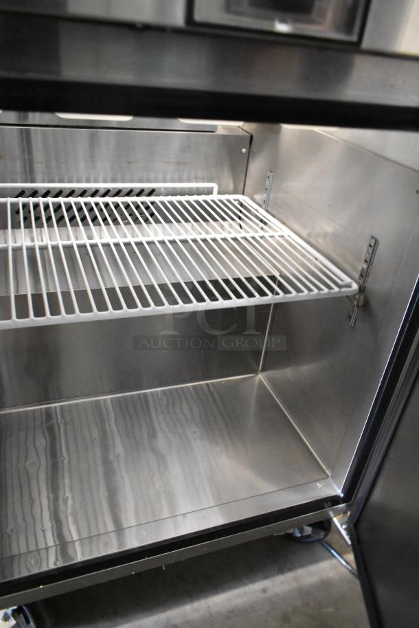 2016 Atosa MSF8301 stainless steel prep table interior, showing clean shelving and commercial casters. 115 volts, 1 phase.