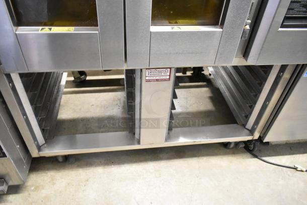 Baxter stainless steel commercial mini rotating rack oven on double pan rack with casters. Trademark Equipment label visible.