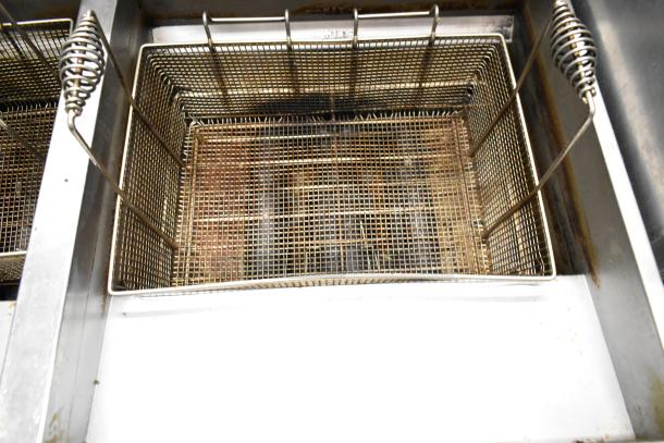 Vulcan 2TR65CF 70 lb capacity deep fat fryer, stainless steel, dual bay, natural gas, with filtration system, on casters.