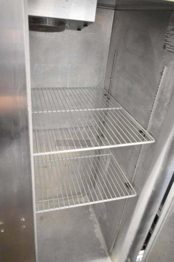 Continental 2R stainless steel commercial 2-door reach-in cooler, poly-coated racks, on commercial casters, good condition.