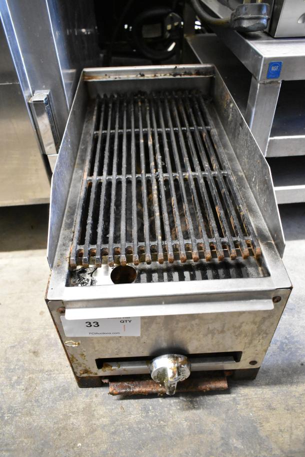 Stainless steel gas-powered charbroiler grill, commercial countertop model with visible wear and adjustable knob.