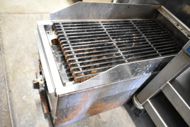 Stainless steel commercial countertop gas charbroiler grill, used condition, featuring a robust iron grate and control knobs.