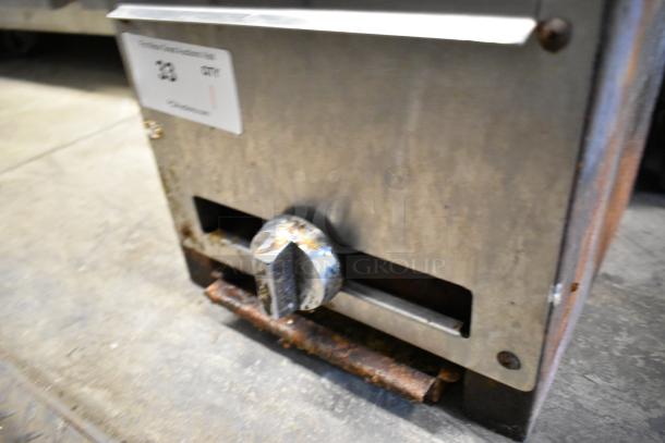 Stainless steel commercial countertop gas charbroiler grill with visible knob and rust. Auction label reads "38 CMP".
