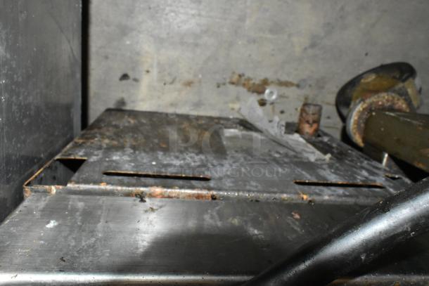 Stainless steel commercial countertop gas charbroiler grill, showing visible wear and rust on surface, for auction.