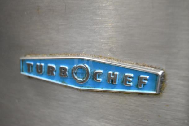 Turbochef logo on stainless steel commercial rapid cook oven, Model NGC, with slight wear and blue background.