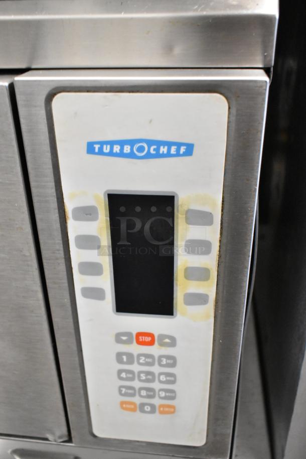 Turbochef NGC stainless steel rapid cook oven control panel, featuring keypad and stop button, on equipment stand.