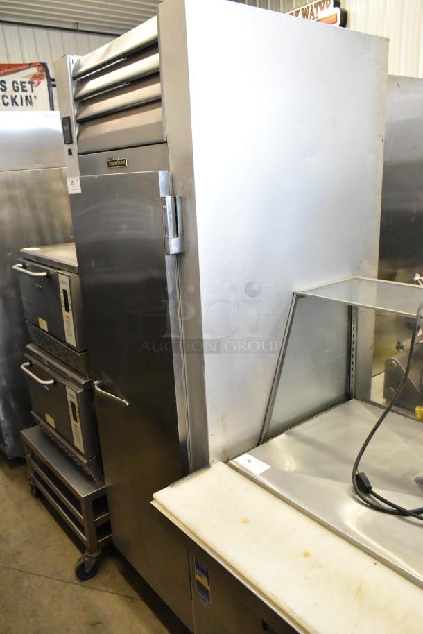 Traulsen G10010 stainless steel commercial single door reach-in cooler with poly-coated racks, on commercial casters.