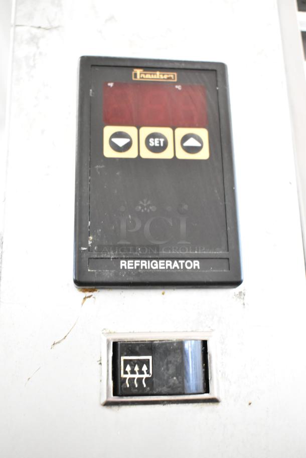 Traulsen G10010 stainless steel reach-in cooler control panel with settings and indicator lights, model name visible.