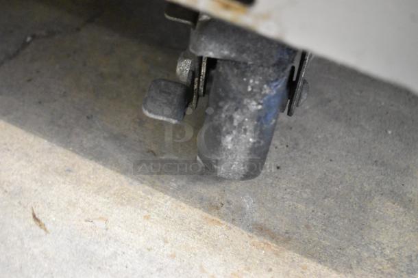 Everest EPBR2 stainless steel commercial prep table caster. Shows table mobility on commercial casters.
