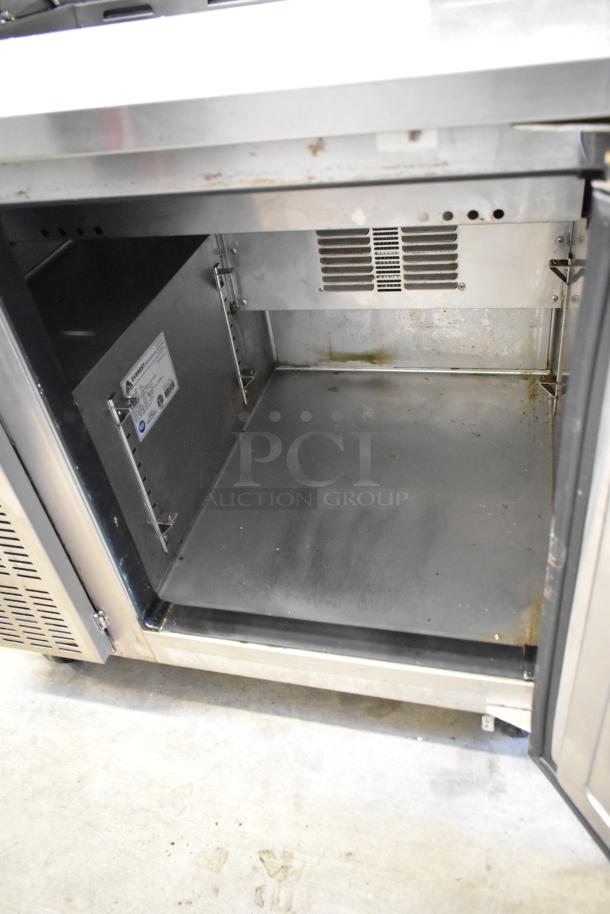 Everest EPR1 stainless steel prep table interior, with open door showing light wear. Includes commercial casters and 115V power.
