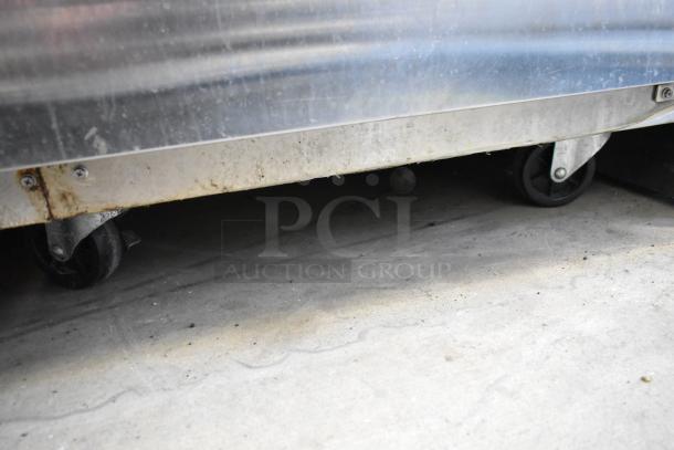 Everest ESR1 stainless steel cooler on commercial casters, featuring poly-coated racks. Visible wear on the base.