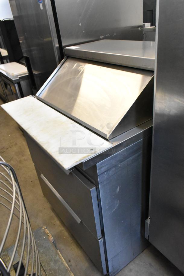 Randell 941452D7 stainless steel prep table with two drawers, cutting board, bain marie top, on commercial casters.