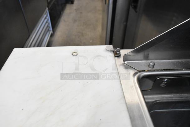 Randell 941452D7 stainless steel prep table detail, showing stainless steel surfaces and white cutting board.