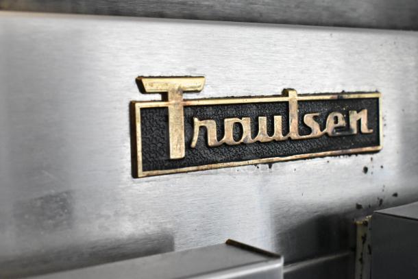 Traulsen G20010 stainless steel logo on 2-door commercial cooler, featuring poly-coated racks, 115V, on casters.