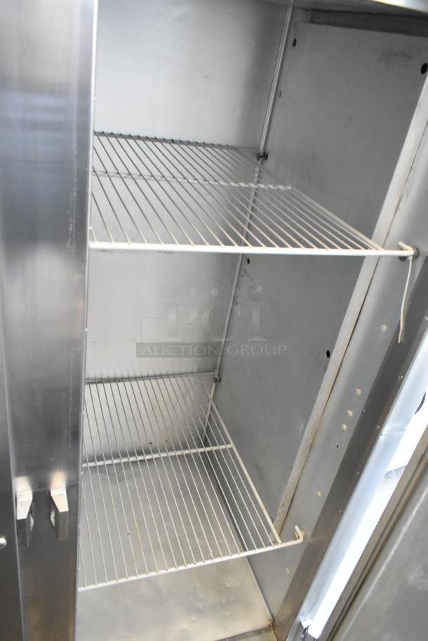Traulsen G20010 stainless steel 2-door reach-in cooler with poly-coated racks, on commercial casters. 115 volts, 1 phase.